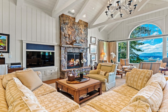 living room with beam ceiling, light hardwood / wood-style flooring, a chandelier, a fireplace, and wood ceiling