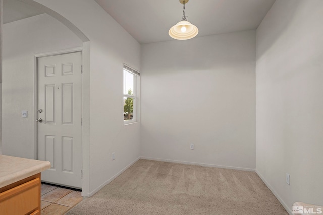 unfurnished room featuring light carpet