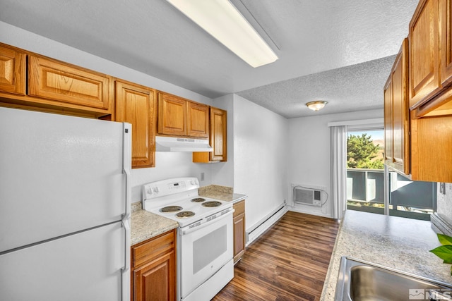 kitchen with white appliances, dark wood-type flooring, light countertops, under cabinet range hood, and a baseboard heating unit