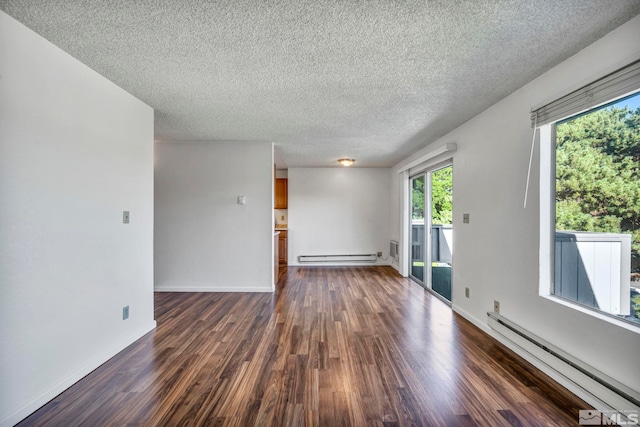 spare room featuring a textured ceiling, a baseboard radiator, a baseboard heating unit, baseboards, and dark wood finished floors