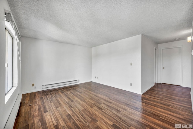 spare room featuring a baseboard radiator, dark wood finished floors, and a textured ceiling