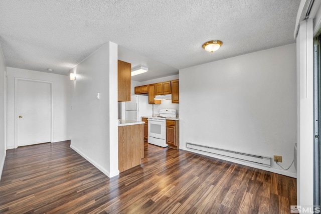 kitchen featuring white appliances, brown cabinets, baseboard heating, light countertops, and under cabinet range hood