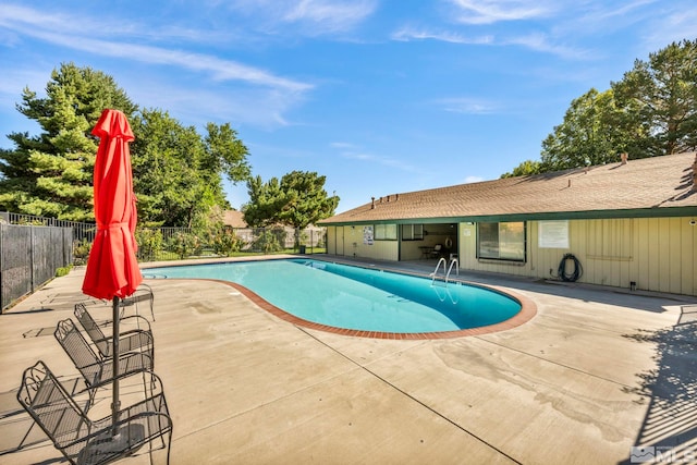 pool with fence and a patio