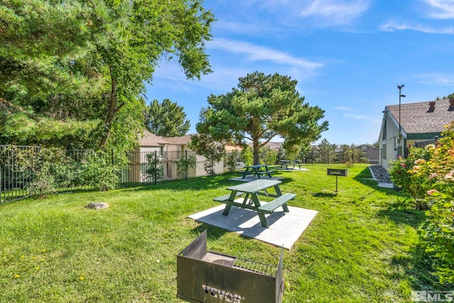 surrounding community featuring a patio area, fence, and a lawn