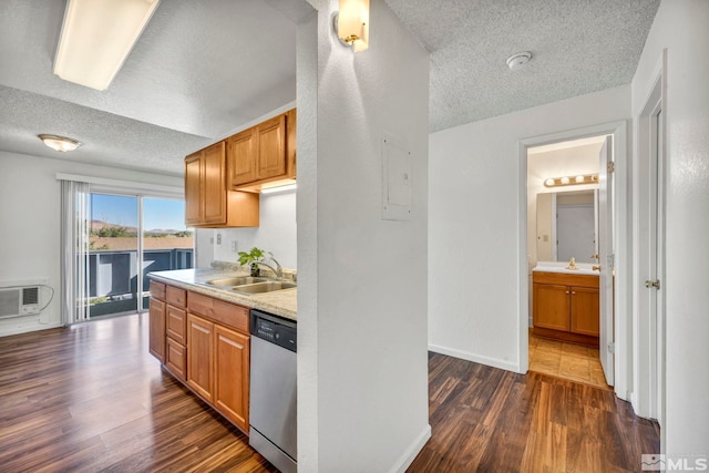 kitchen featuring a textured ceiling, dark wood-type flooring, and stainless steel dishwasher