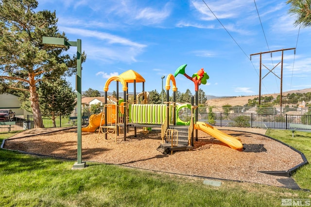 community jungle gym featuring fence and a mountain view