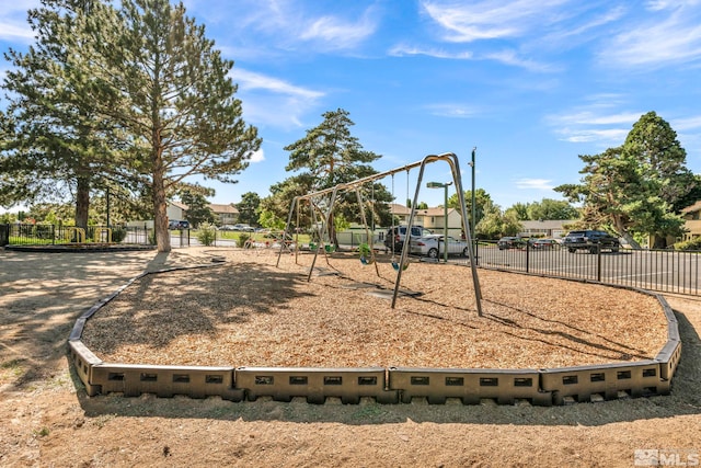 community playground featuring a residential view and fence