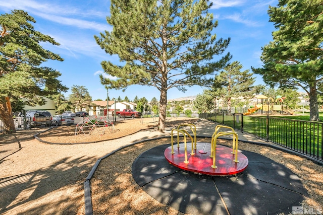 view of community featuring playground community and fence