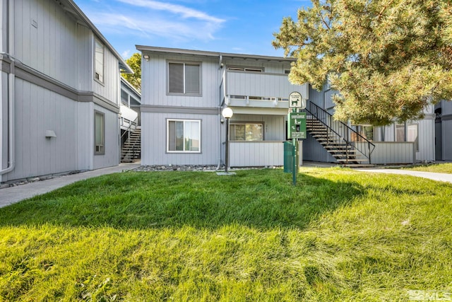 view of front of property with a front yard and stairway