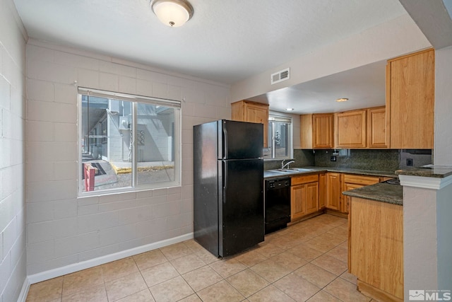 kitchen featuring black appliances, visible vents, a wealth of natural light, and a sink