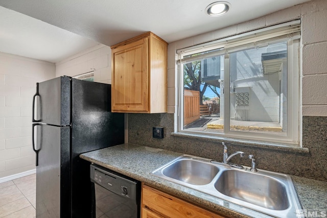 kitchen with black appliances, backsplash, dark countertops, and a sink