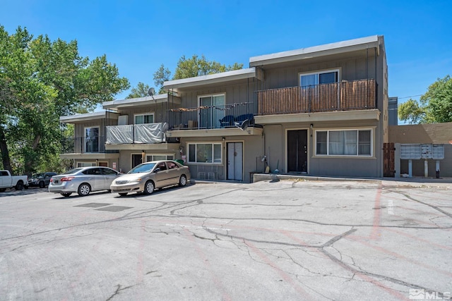 view of property featuring uncovered parking and board and batten siding