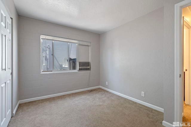 unfurnished bedroom with light carpet, baseboards, and a textured ceiling