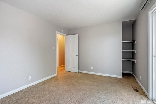 unfurnished bedroom with light carpet, baseboards, and visible vents