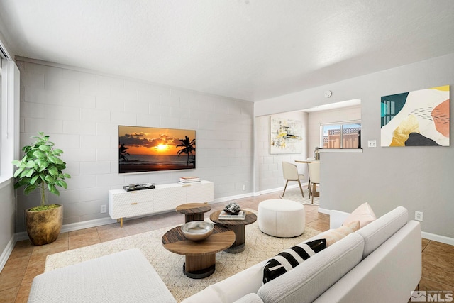 living area featuring tile patterned flooring and baseboards