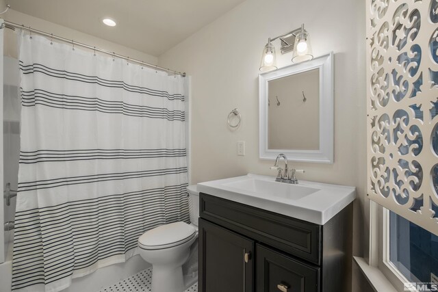 bathroom with tile patterned floors, vanity, and toilet