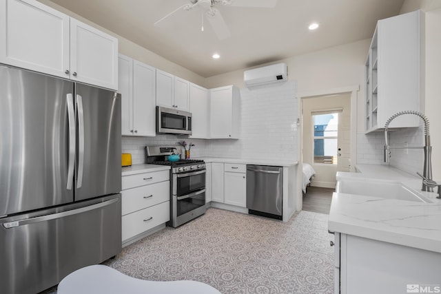 kitchen with ceiling fan, appliances with stainless steel finishes, sink, and backsplash