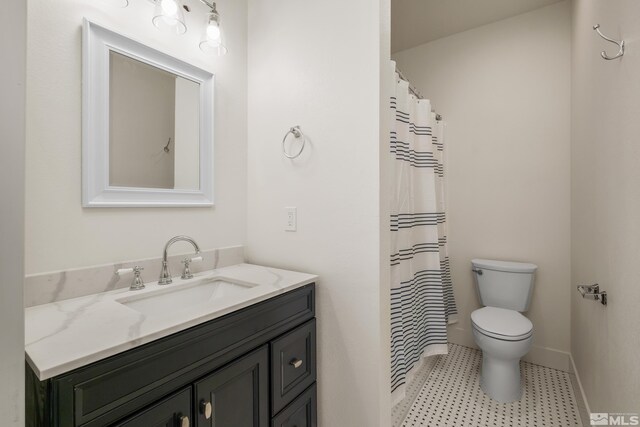 bathroom with tile patterned floors, toilet, and vanity