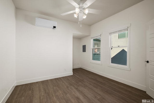 spare room with electric panel, baseboards, dark wood finished floors, ceiling fan, and a wall mounted air conditioner