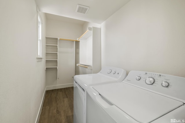 washroom featuring dark wood-type flooring and washer and clothes dryer