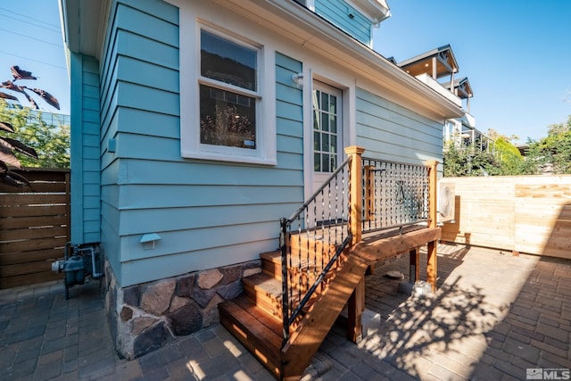 wooden deck featuring fence and a patio