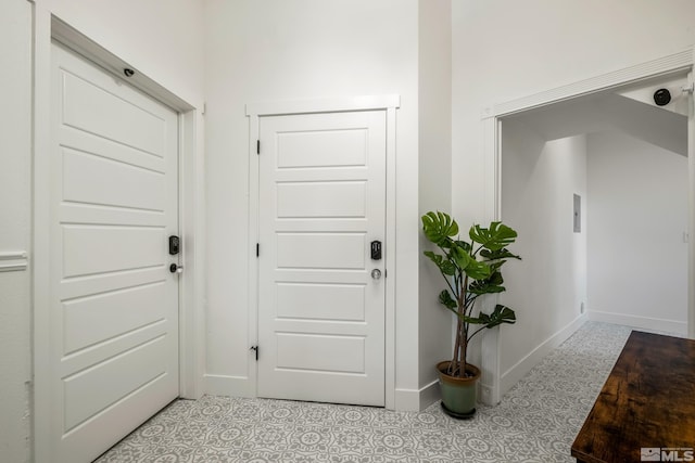 doorway with tile patterned floors