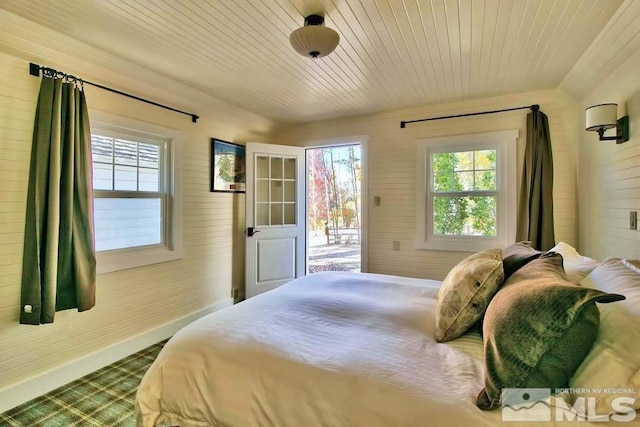 bedroom with access to exterior and wood ceiling