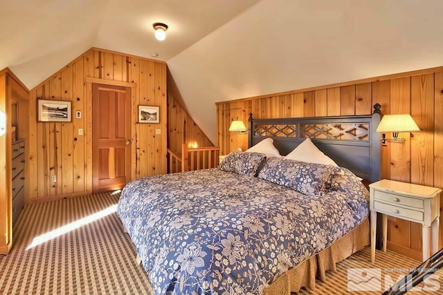 bedroom featuring carpet, wood walls, and lofted ceiling