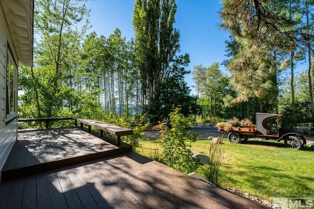 wooden deck with a lawn