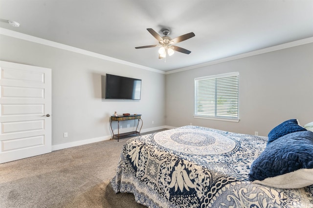 carpeted bedroom with ceiling fan, baseboards, and crown molding