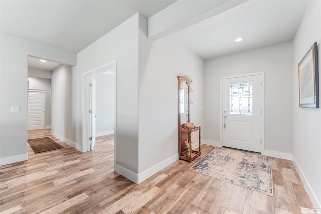 foyer entrance with light wood-type flooring, baseboards, and recessed lighting