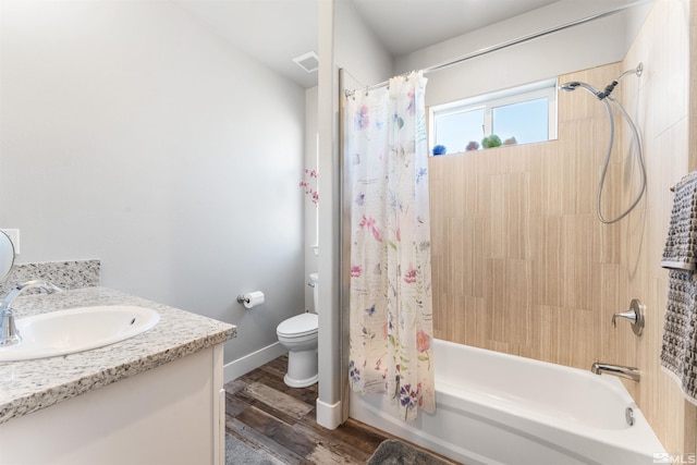 bathroom with toilet, shower / bath combo, vanity, wood finished floors, and baseboards