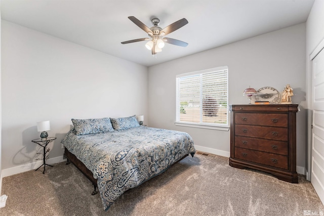 carpeted bedroom featuring a ceiling fan and baseboards