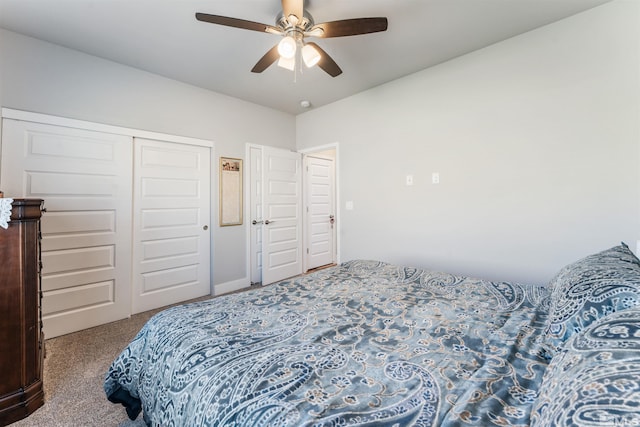 carpeted bedroom featuring a ceiling fan and a closet