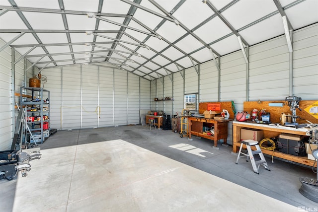 garage with a workshop area and metal wall