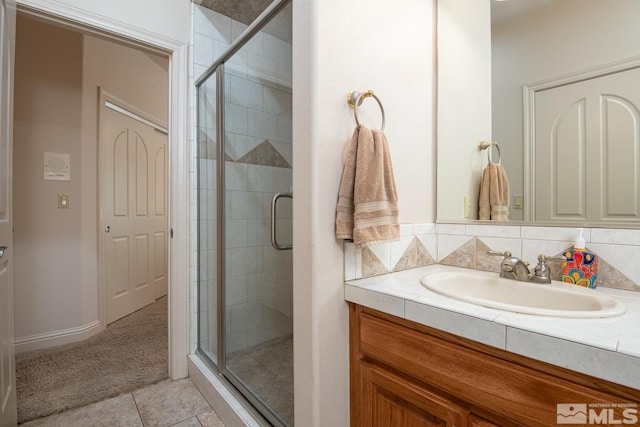 bathroom featuring a shower stall, vanity, and tile patterned floors