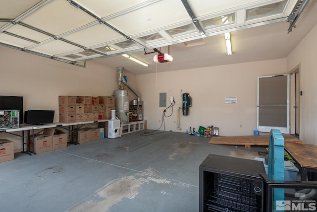 garage with a garage door opener, secured water heater, and a workshop area