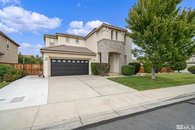 mediterranean / spanish house featuring fence, stone siding, driveway, stucco siding, and a front lawn