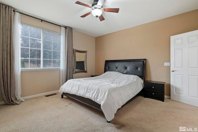 bedroom featuring ceiling fan and light carpet