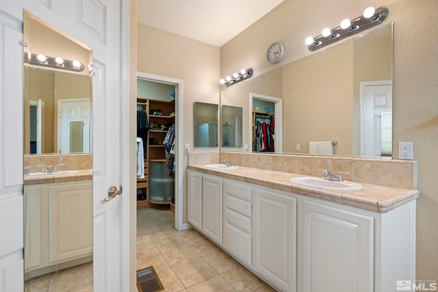 bathroom with tile patterned floors and vanity