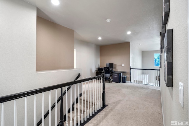 hallway featuring light carpet, an upstairs landing, and recessed lighting