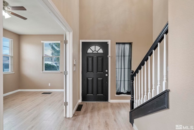 foyer featuring ceiling fan, plenty of natural light, and light hardwood / wood-style floors