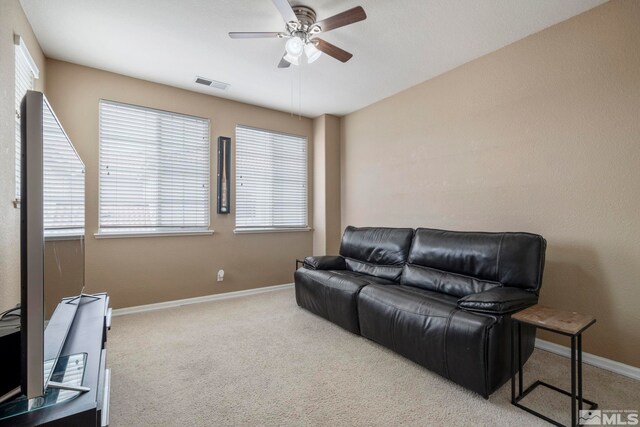 carpeted living room with plenty of natural light and ceiling fan