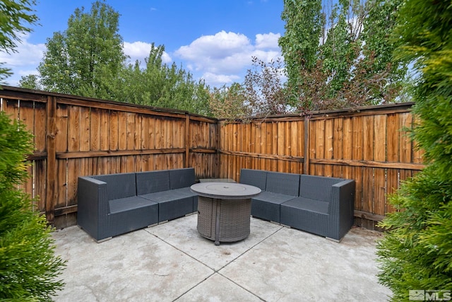 view of patio / terrace featuring a fenced backyard and an outdoor living space with a fire pit