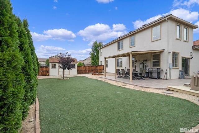 view of yard with a patio area and an outbuilding