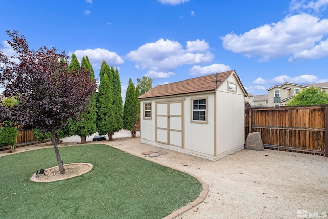 view of shed featuring a fenced backyard