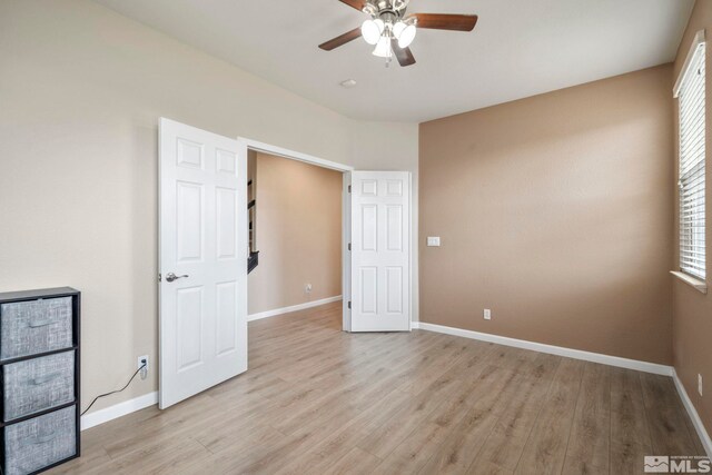 unfurnished bedroom featuring light wood-type flooring and ceiling fan