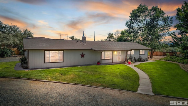 ranch-style house with a yard