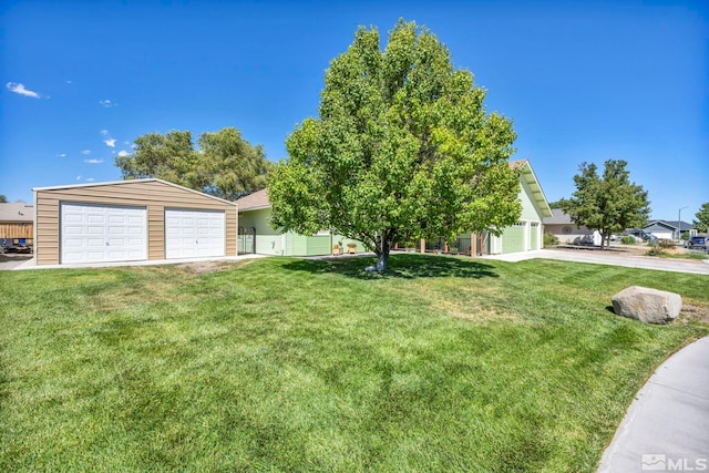 view of front of property with a garage and a front lawn