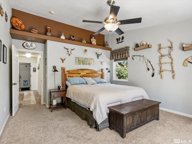 bedroom featuring ceiling fan and light carpet